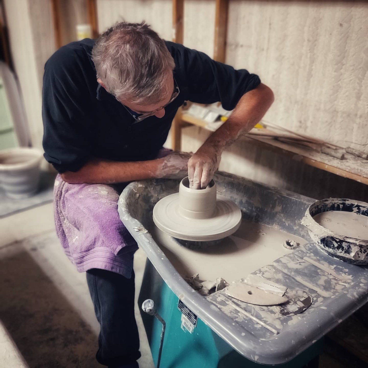 David Stubley throwing a vessel at the pottery wheel.