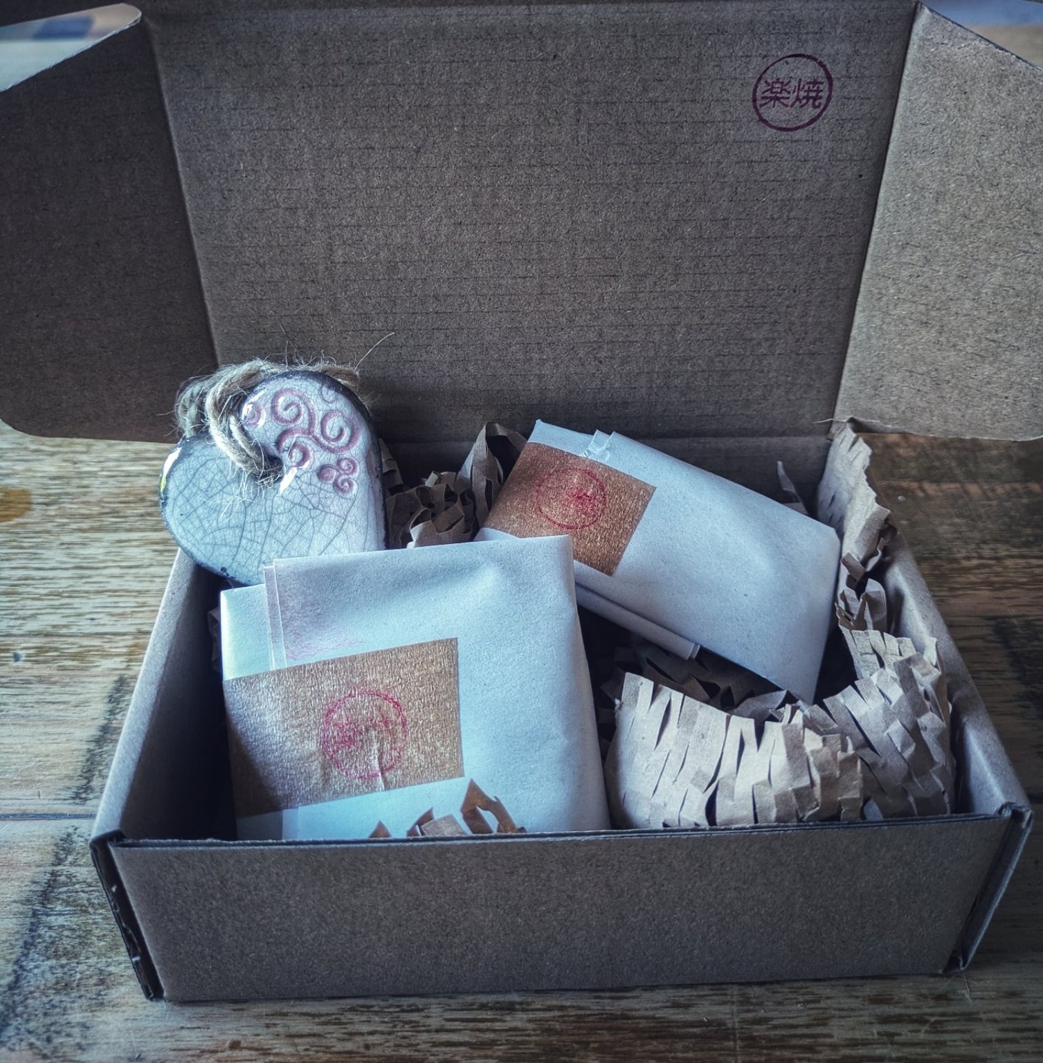 A finished ceramic piece packed with wrapping and studio packaging, ready to be sent out.