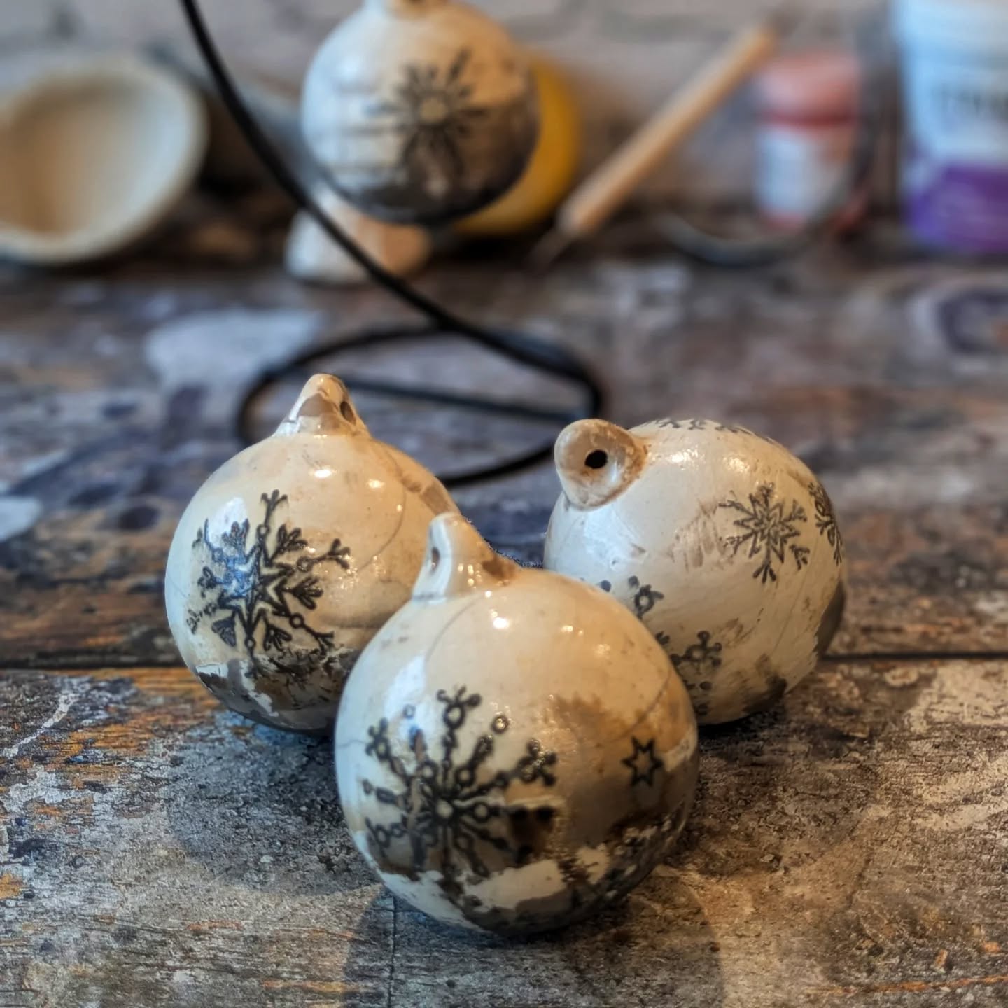 Three finished snowflake raku Christmas tree baubles.