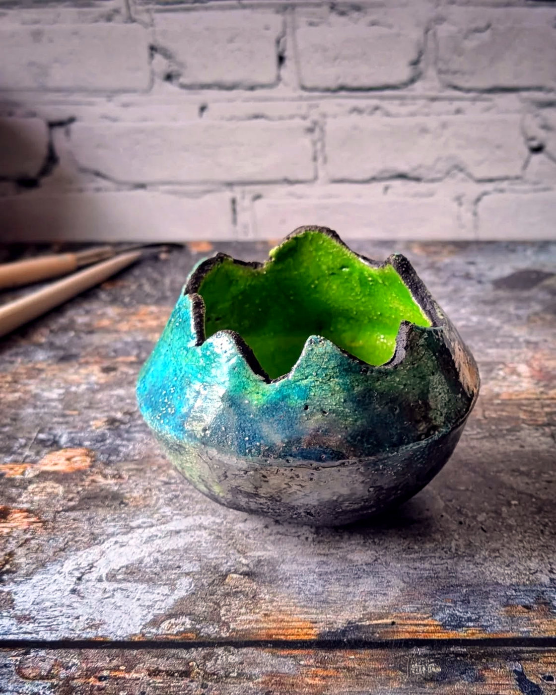 Sculptural vessel with an irregular rim, blue-green crackled exterior and vivid green interior.